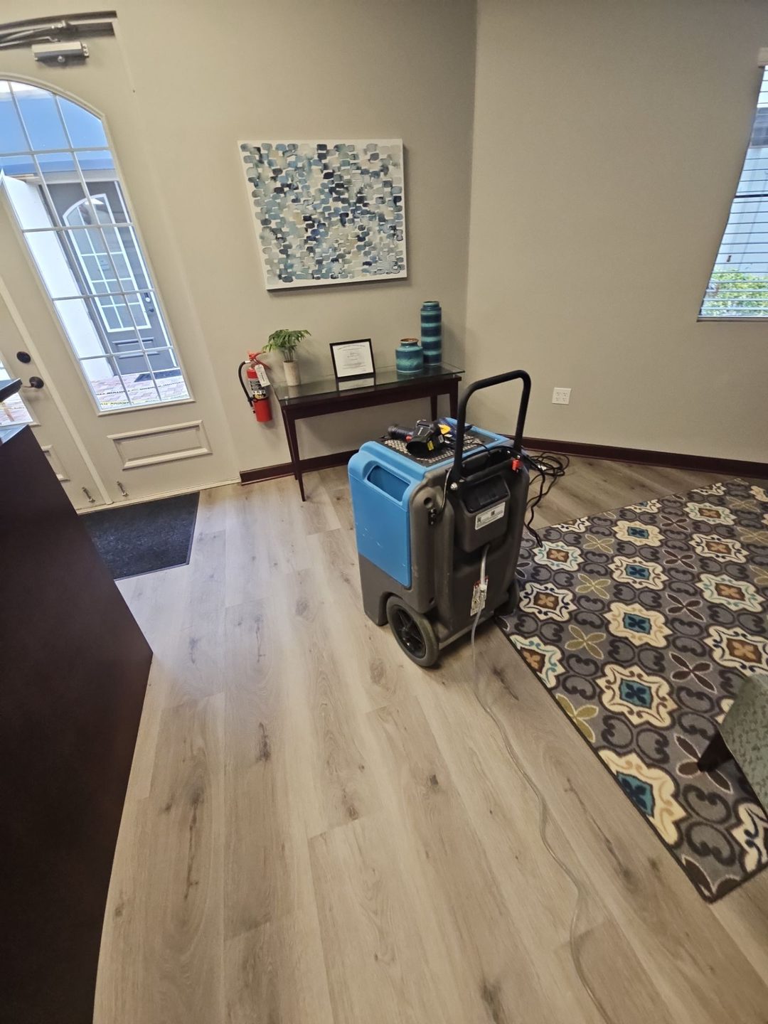 Dehumidifier running in the reception area of a commercial building after flooding