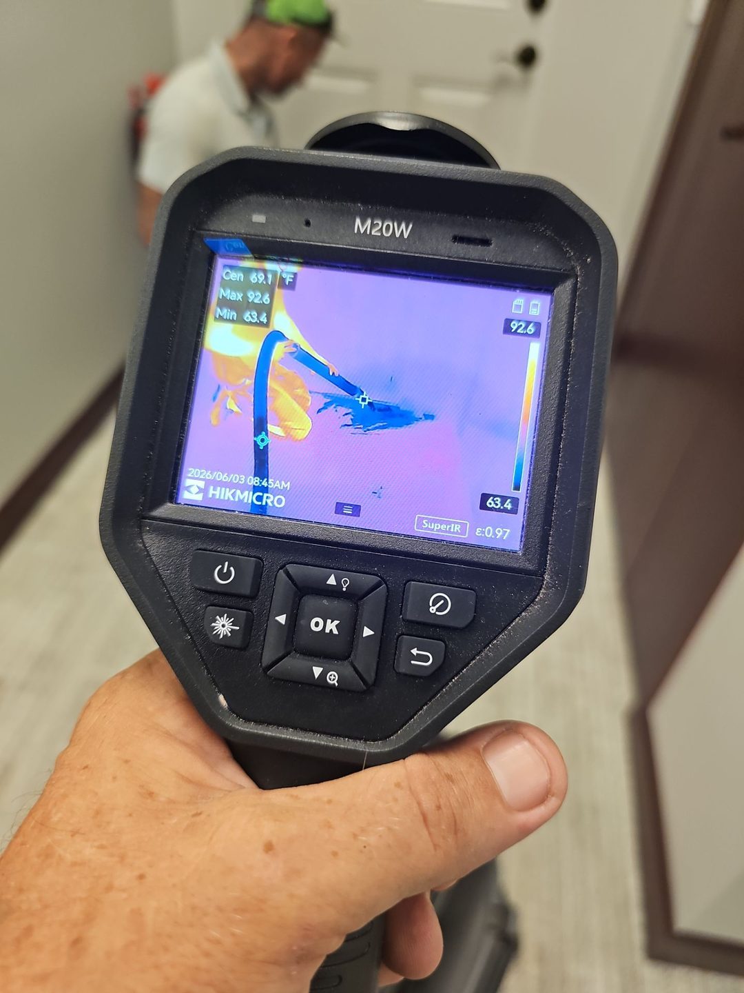 Thermal camera reading showing moisture near the floor in a commercial building