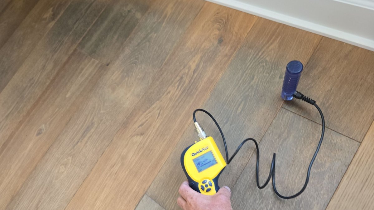 Moisture meter reading on a floor during a water damage inspection in Melbourne, FL