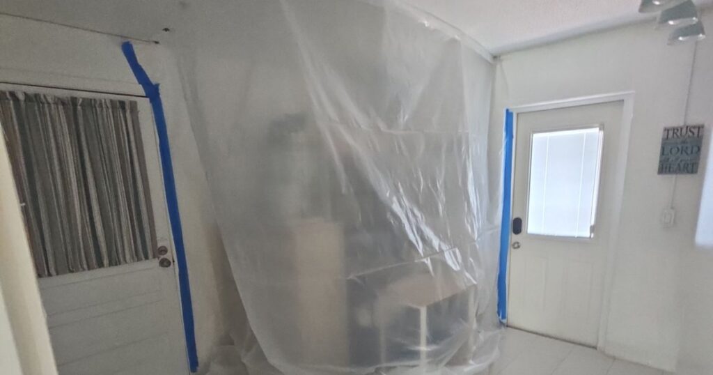 Plastic containment set up before mold removal in a Brevard County home