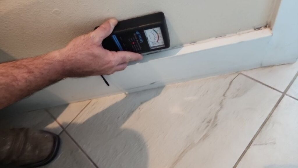 Moisture meter reading at baseboard in Satellite Beach, FL – Affordable Water and Mold Removal job photo