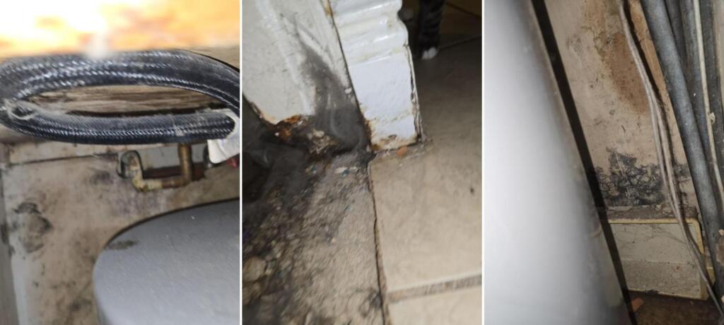 A corroded water heater connection, water staining and debris at the base of a door frame, and mold growth on a wall beside water heater piping in a Titusville rental